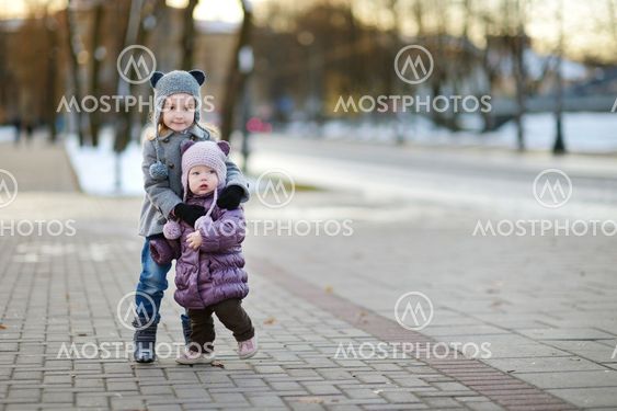 Two sisters having fun at winter city