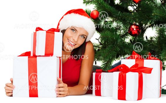 smiling woman in santa helper hat with gift boxes