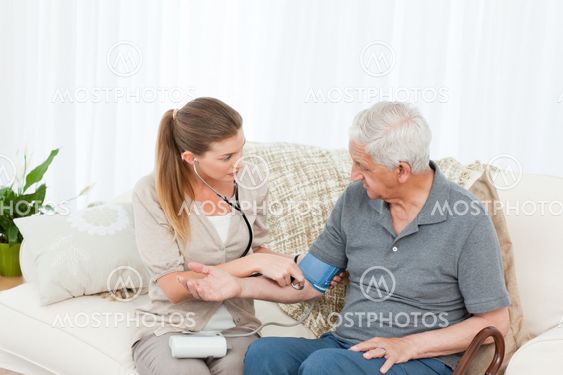 Lovely nurse helping her patient to do exercises