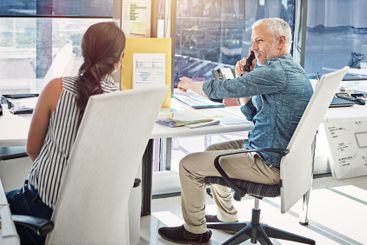 Office, phone call and business people at desk for...