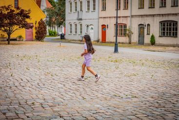 Girl running through medieval and Hansa inspired living...