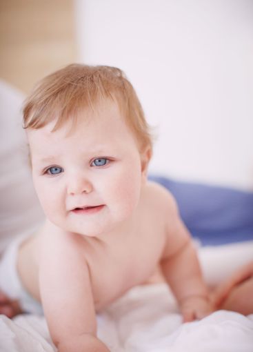 Baby, parent and crawling on bed in home, love and...