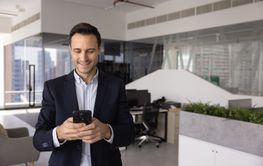 Happy business company leader man using mobile phone in...
