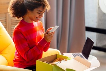 A young attractive African woman in casual clothing is...