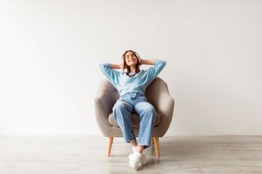 Full length of young Caucasian woman relaxing in...