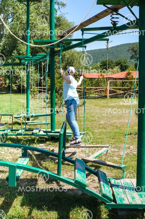 girl overcomes an outdoor obstacle course