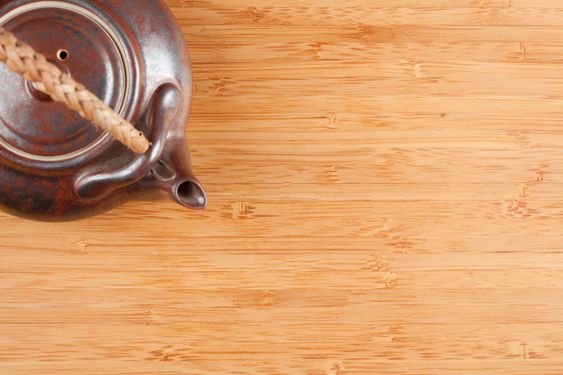 Tea Pot and Bamboo Textured Surface