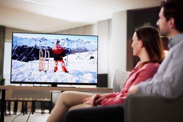 Relaxed couple enjoying movie night in cozy living room