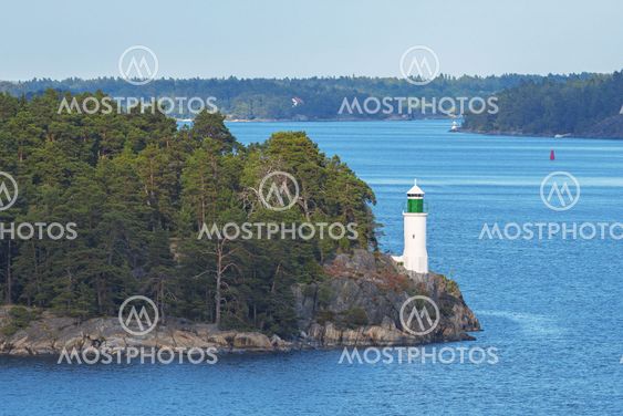 White beacon at coastline in the swedish archipelago...
