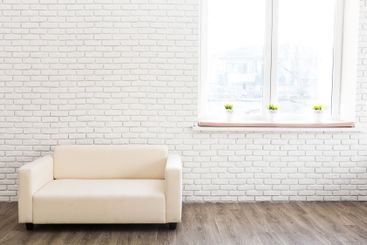 Cozy living room featuring a beige sofa and natural...