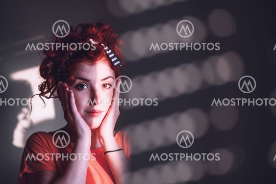 Young woman looking worried by the window