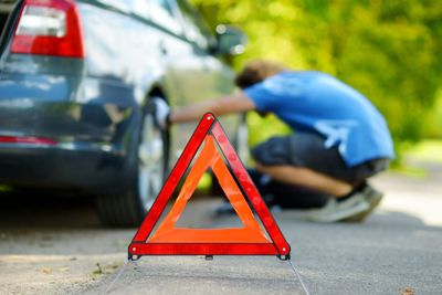 Red warning triangle sign on the road