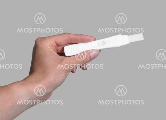 hand holding a pregnancy test