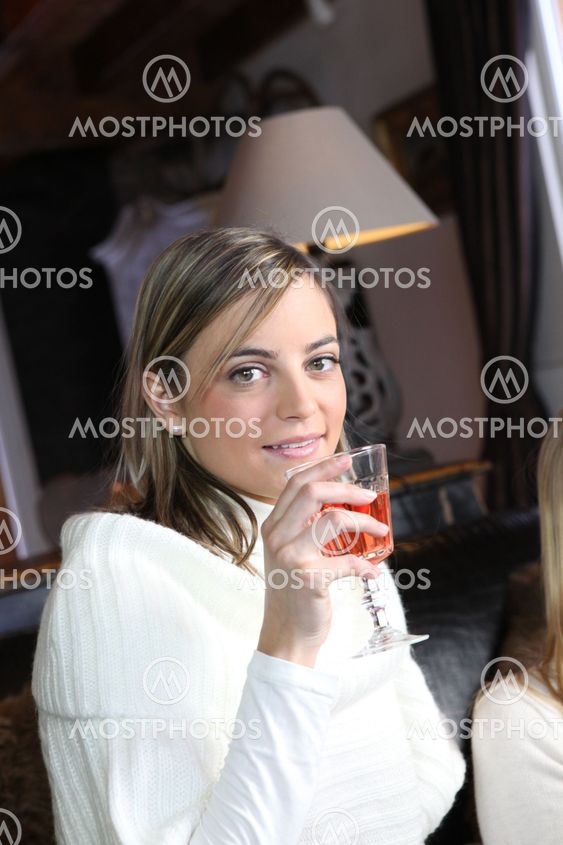Woman drinking wine with friends