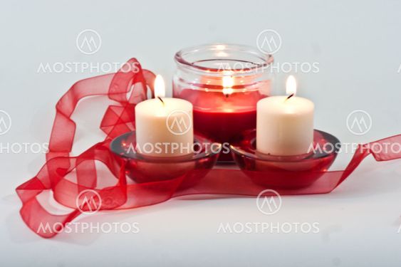 Three Candles with a red ribbon.