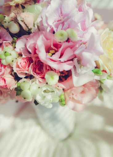 Colorful bouquet of assorted flowers arranged in a glass...