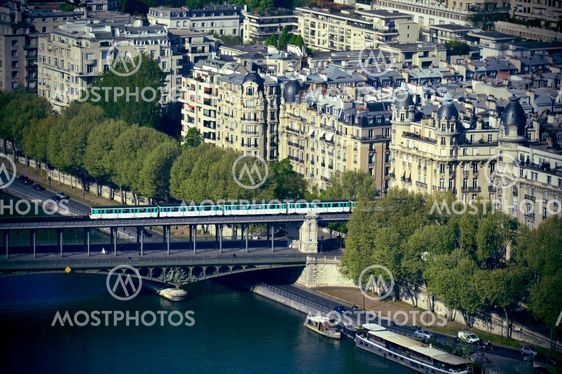 Metro train crossing Passy Bridge over the Seine River in Paris, France