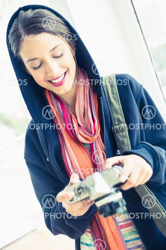 Attractive brunette looking at her camera