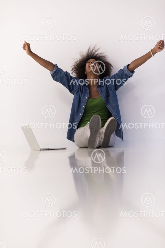 african american woman sitting on floor with laptop