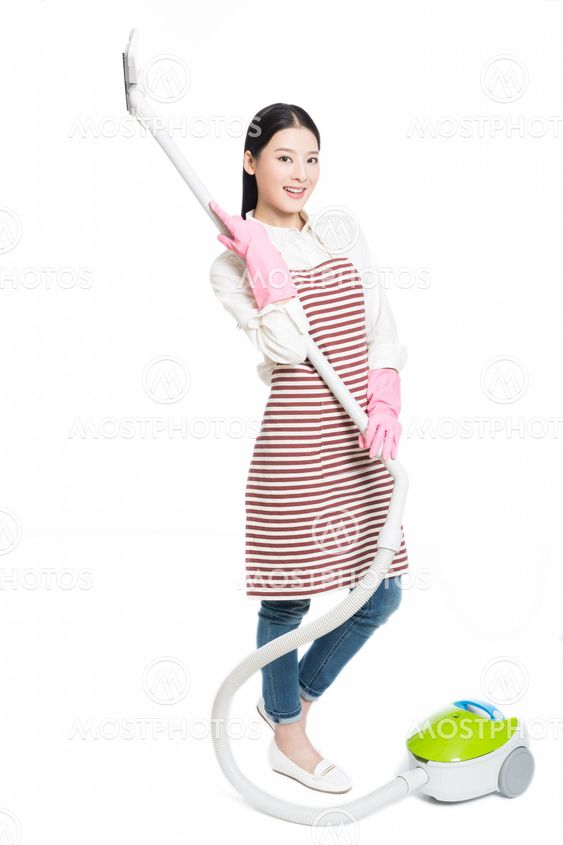 chinese young woman with a vacuum cleaner