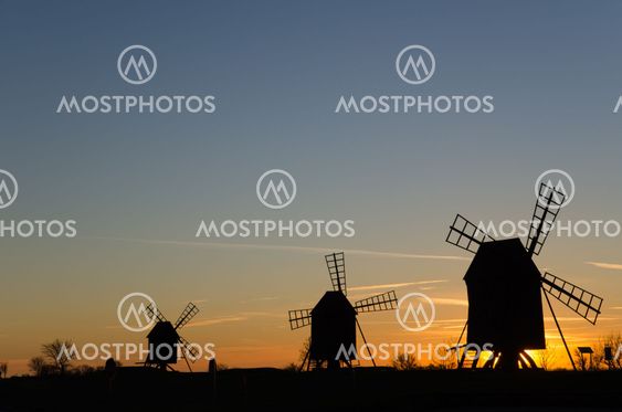 Traditional windmills in a row by sunset