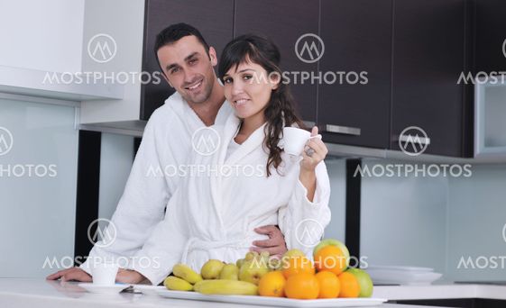 young couple have fun in modern kitchen