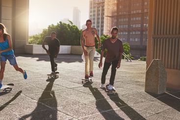 Training, city and group with skateboard, skating and...