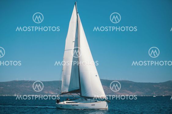Sailing ship luxury yacht with white sails in the Aegean Sea.