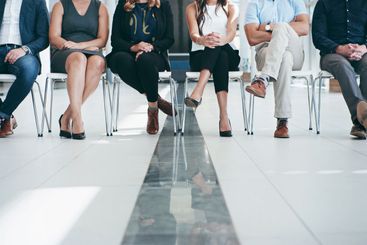Legs, line and business people in waiting room for...