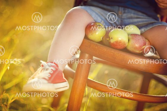 Close up of boy sitting on chair outside