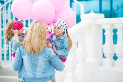 Happy young family on the street of european city.