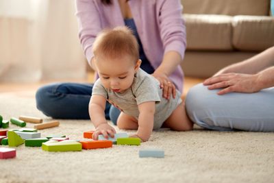 happy family with baby boy playing at home