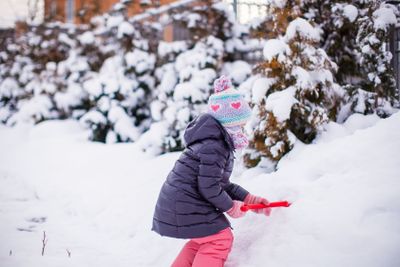 Adorable little girl outdoor in the park on a winter day