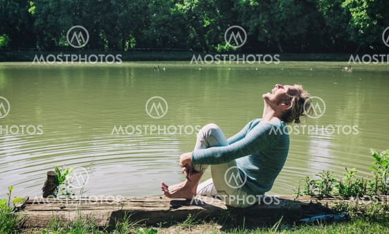 Young man laughing by the river