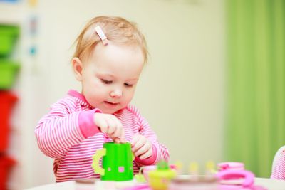 Little girl playing with toys