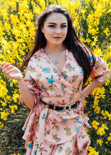 Beautiful woman in summer dress with flowers