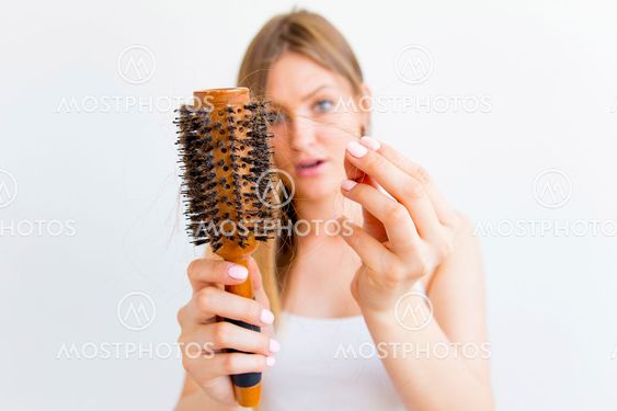 Woman dries and styles her hair