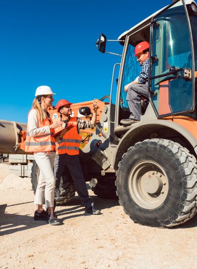 Civil engineer and worker discussion on road construction...