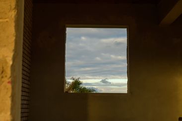 Open window reveals the beauty of the cloudy sky at dusk...