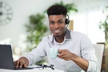 man sitting at desk working from home on computer