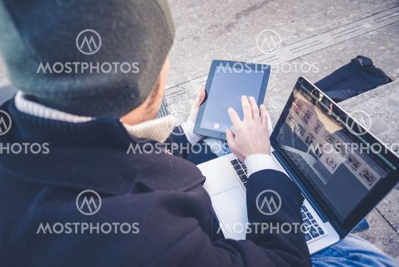 multitasking man using tablet, laptop and cellhpone