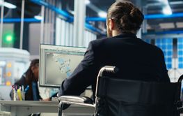 Person with disability inspecting solar plant machinery...