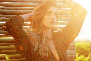 Boho, sunset and woman with fashion outdoor for...