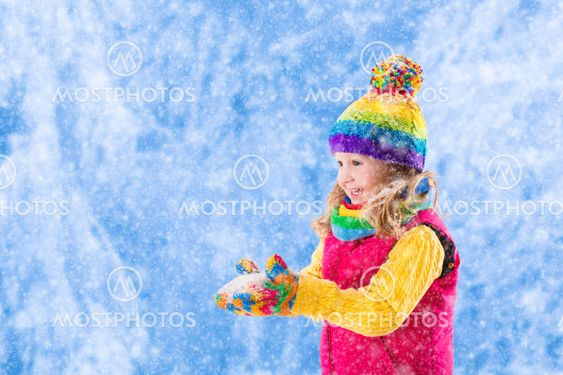 Little girl playing in snowy park