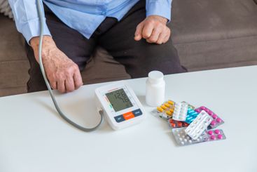 An old woman measures her blood pressure. Selective focus.