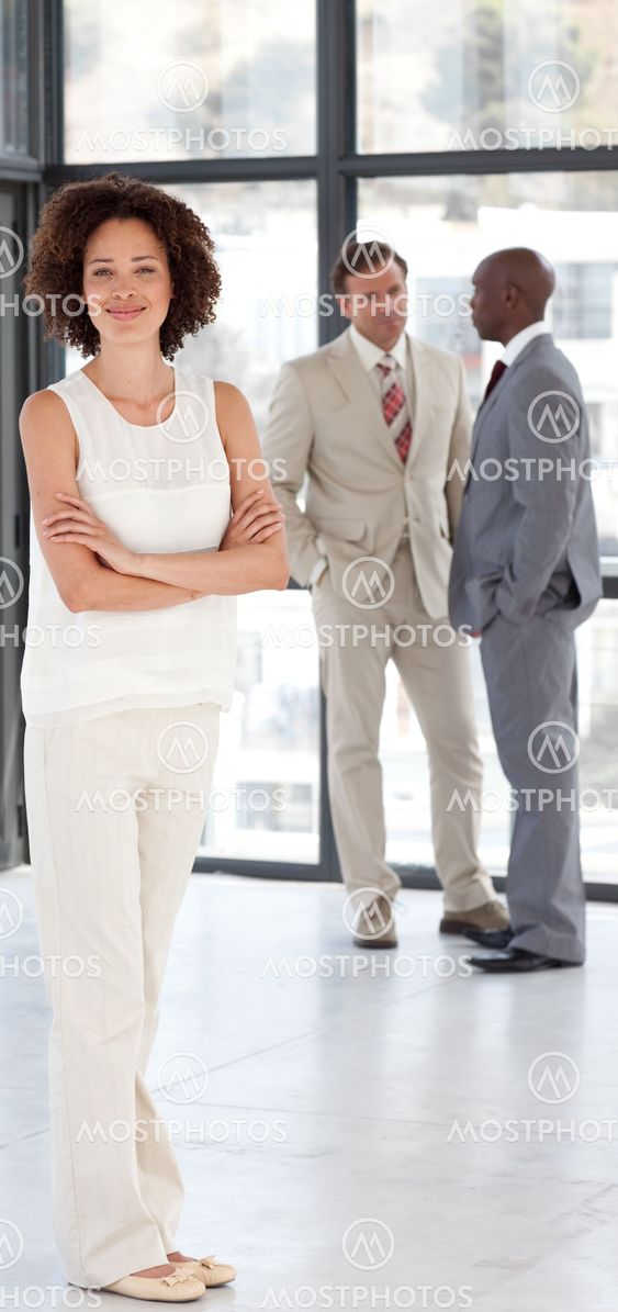 Afro-american Businesswoman arms folded with his colleagues