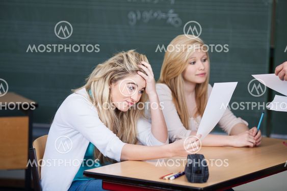 Dissatisfied Female Student Looking At Question Paper In...