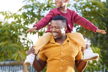 Father, smile and black man piggyback kid, fun and joy...