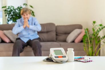 An old woman measures her blood pressure. Selective focus.