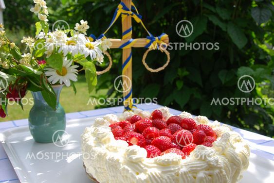 Cake with strawberries and cream at a table